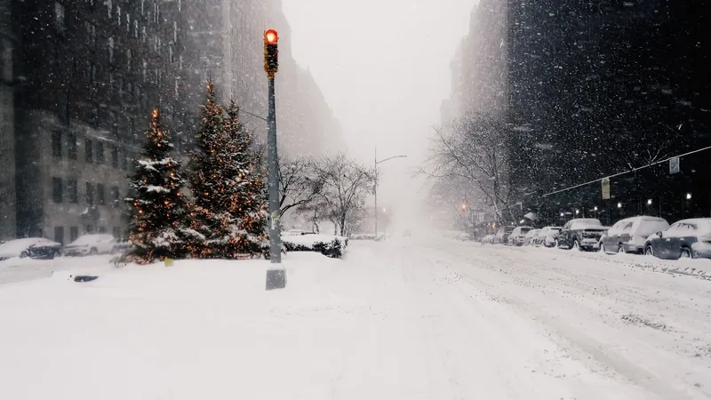 A city street under heavy snowfall, winter banner shown to subscribers in cold weather