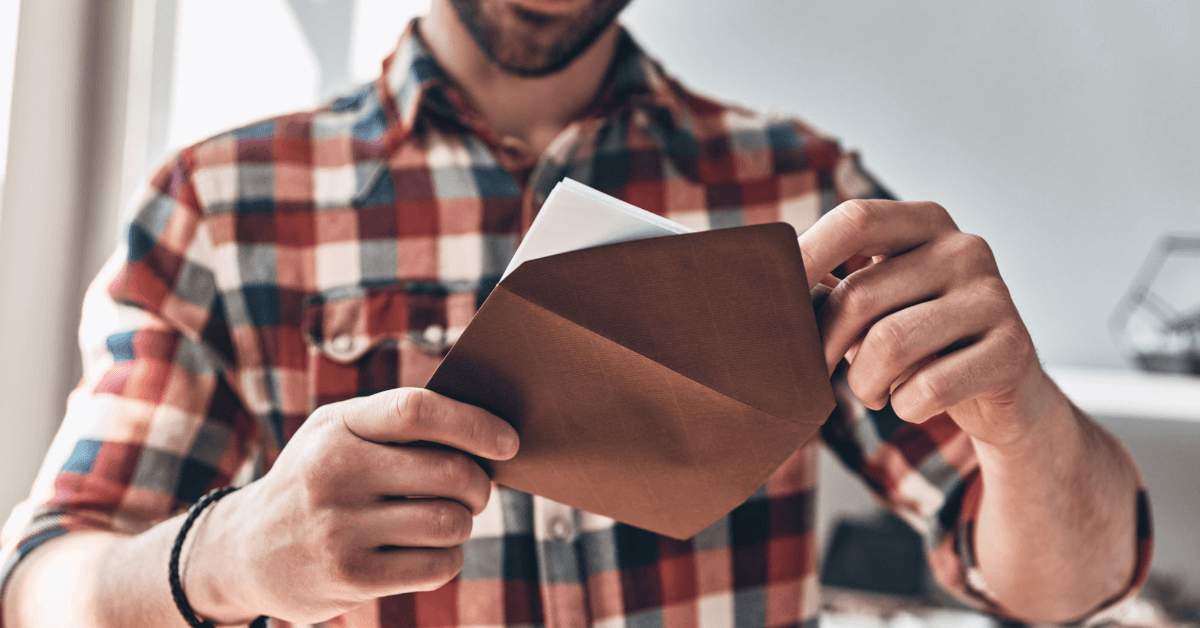 someone opening a letter